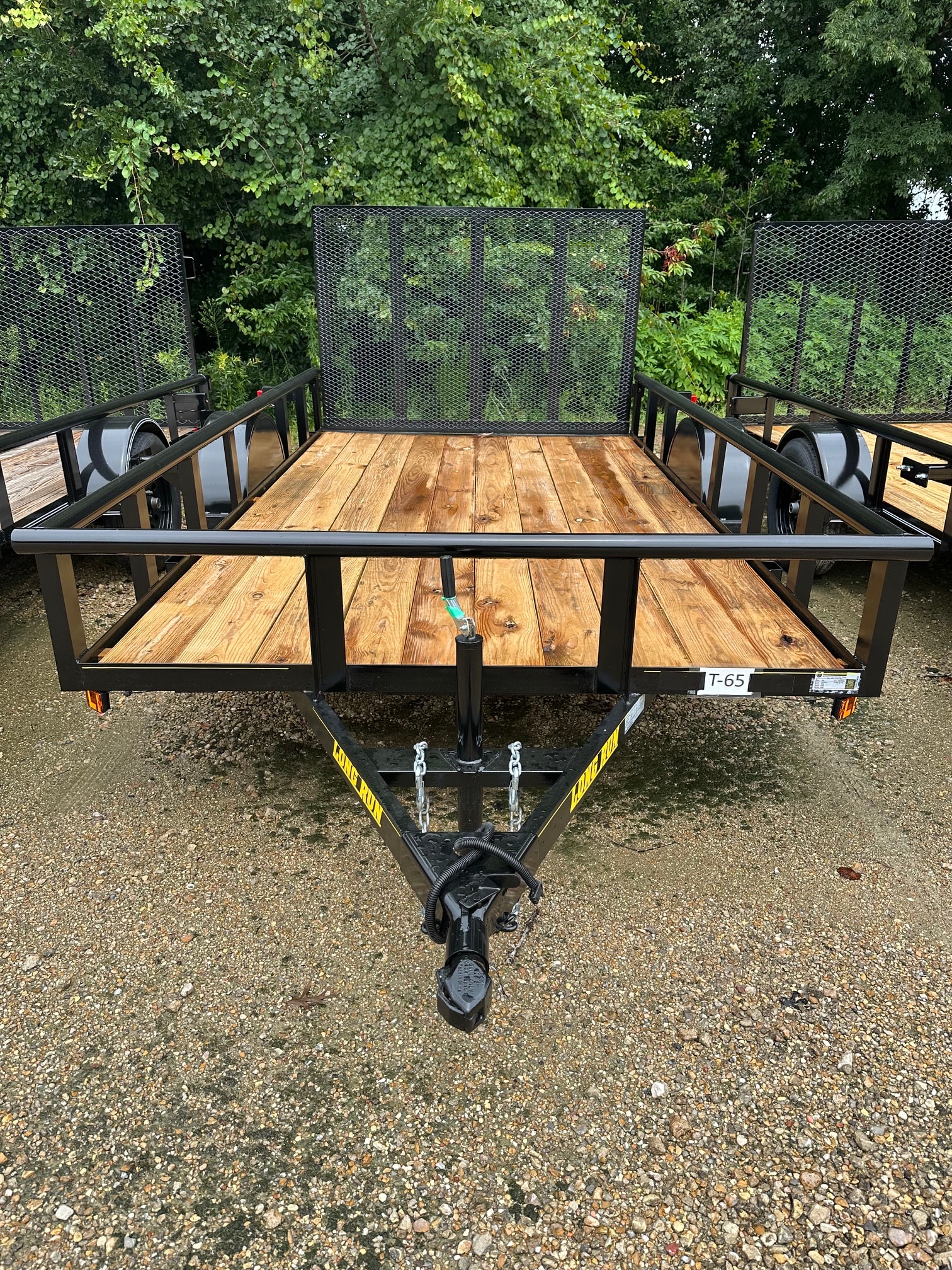 Long Run tandem axle utility trailer with wood deck and expanded metal sides
